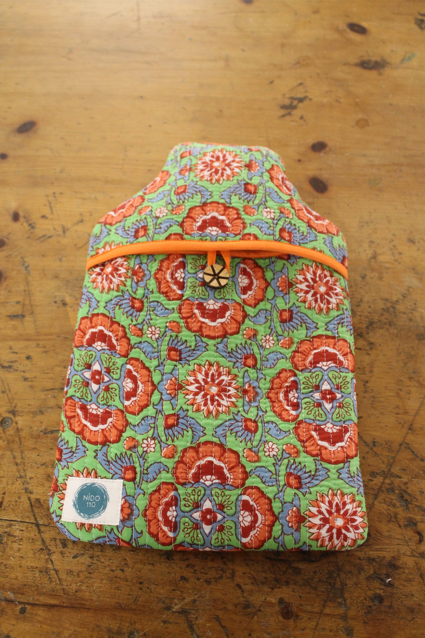 Orange, green and blue hand block printed quilted water bottle cover and bottle inside