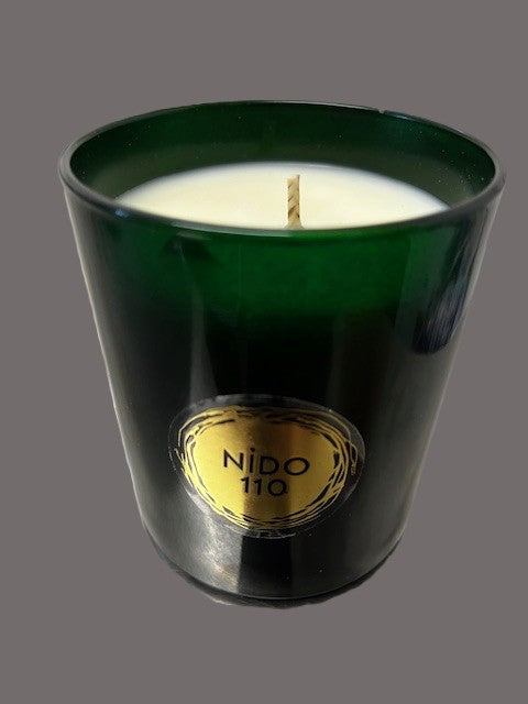 Green candle with a gold label on a gray background soy wax cotton wicks