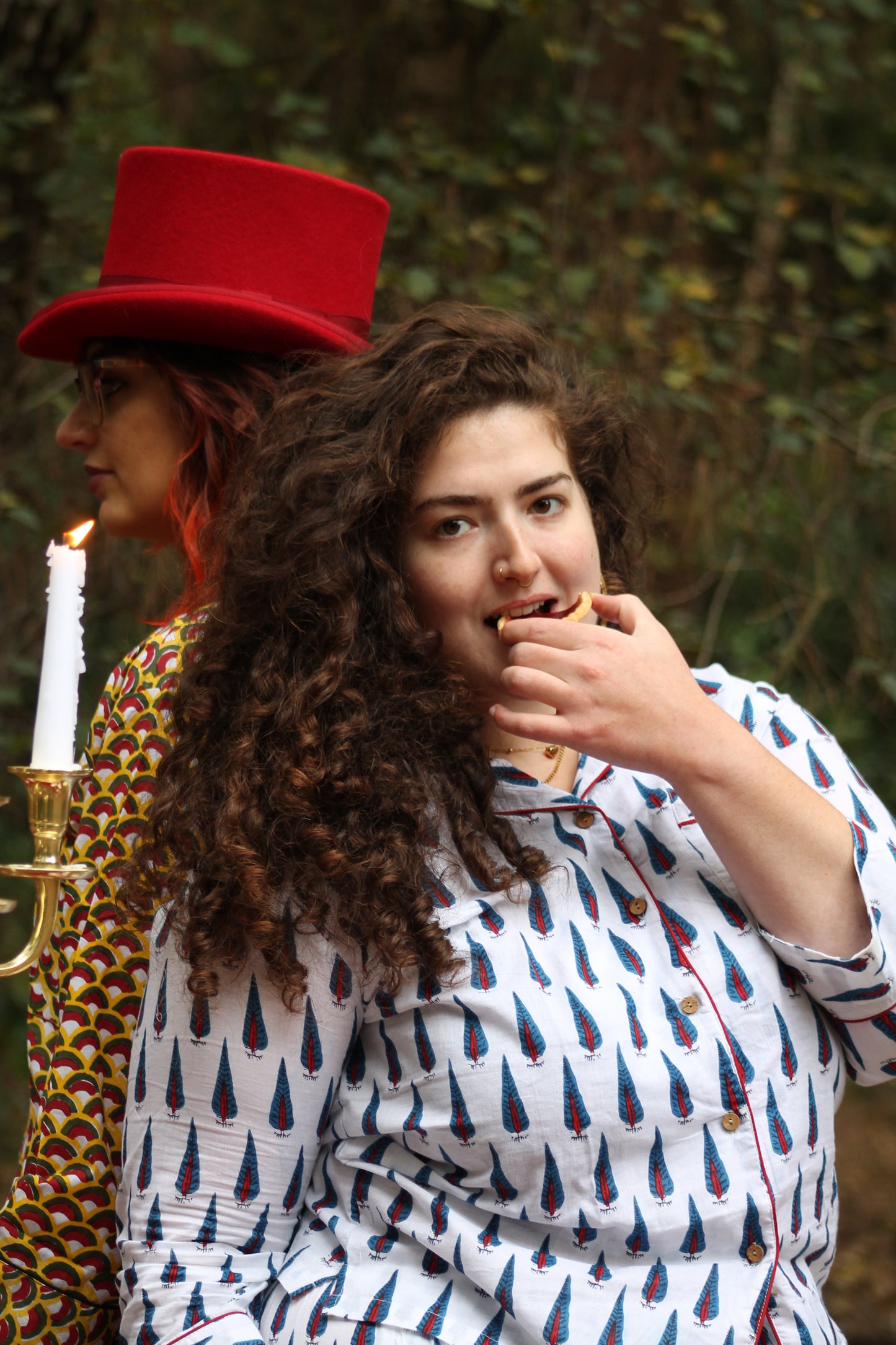 plus size model wearing red white and navy pyjamas close up in forest scene