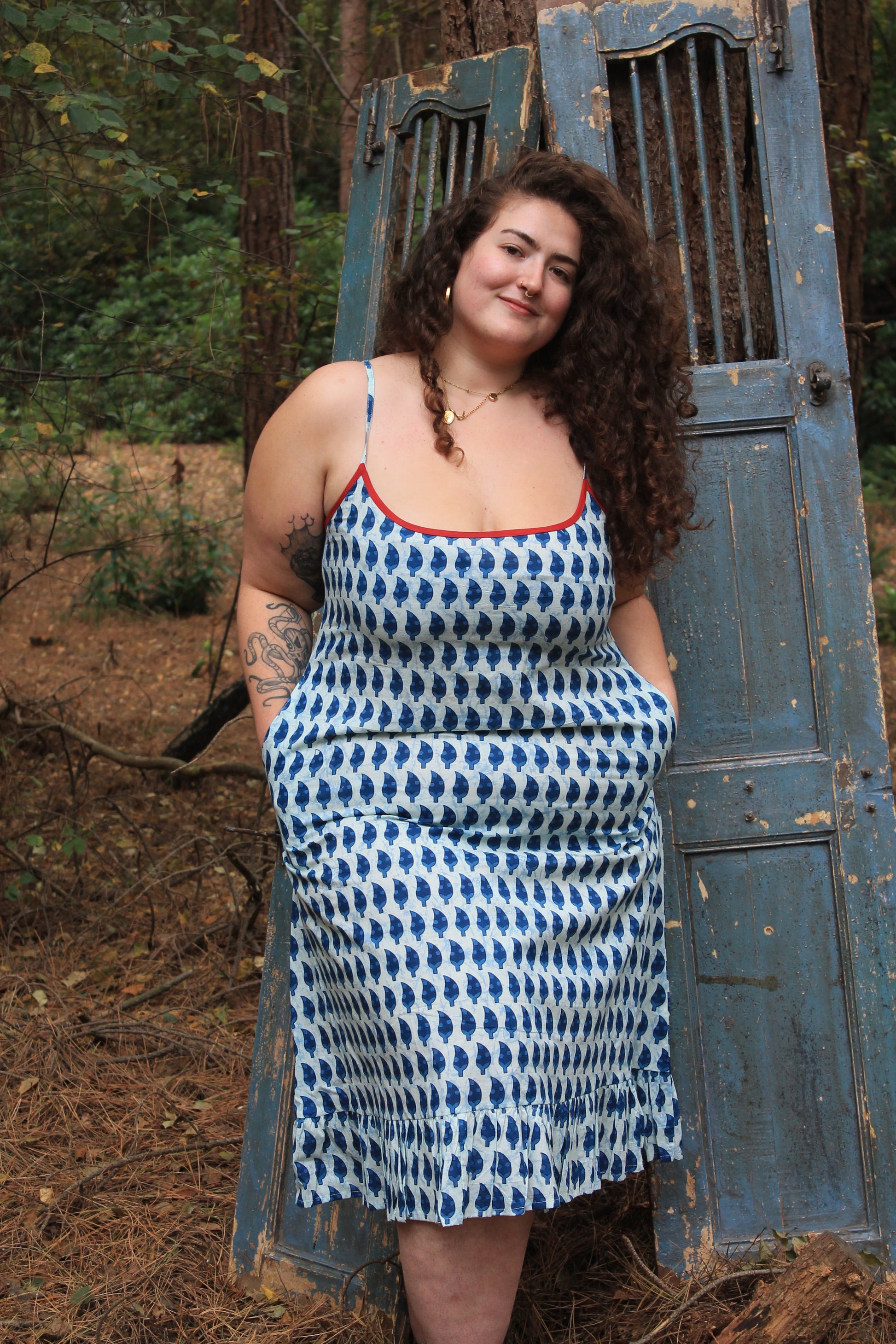 Plus size person wearing indigo blue adjustable spaghetti strap nightdress