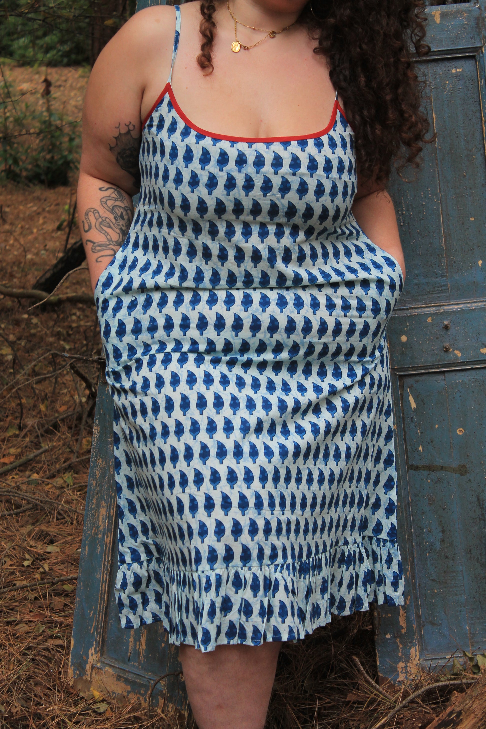 Plus size model wearing indigo blue spaghetti strap nightdress close up full details of design including pockets, hen and colours clearly.