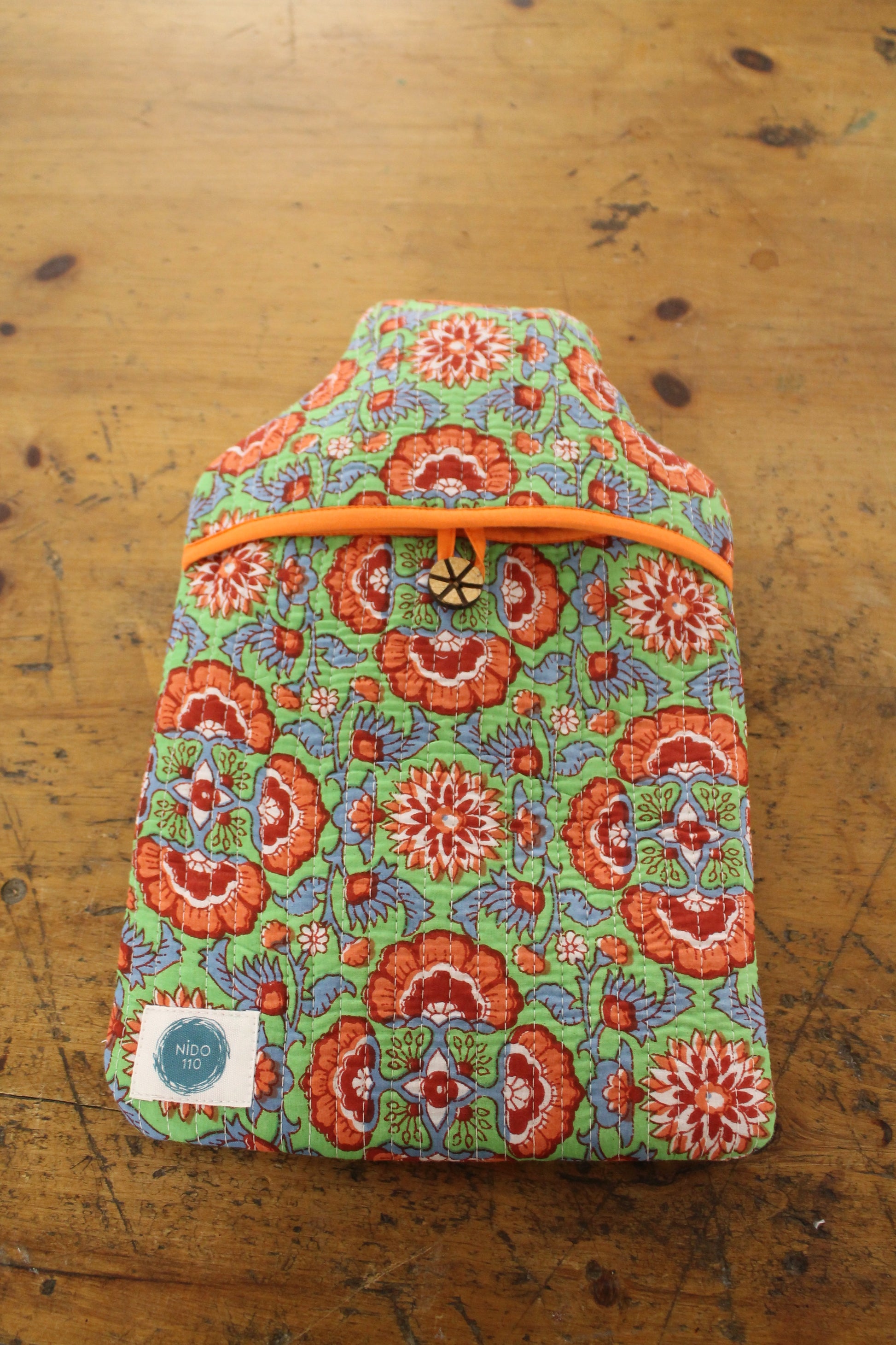 Orange, green and blue hand block printed quilted water bottle cover and bottle inside